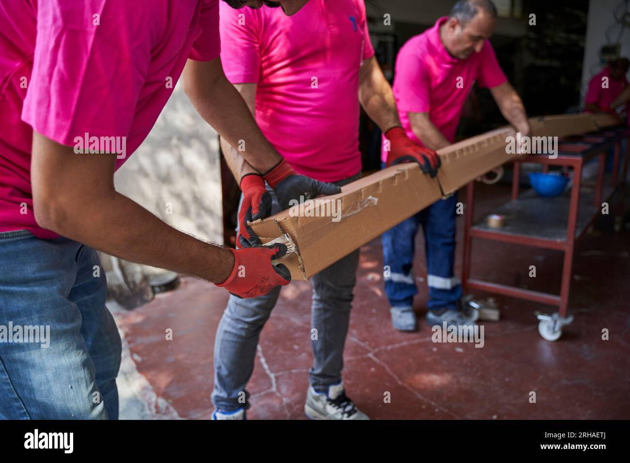 Workers packing cardboard box in warehouse for shipment. an operator ...