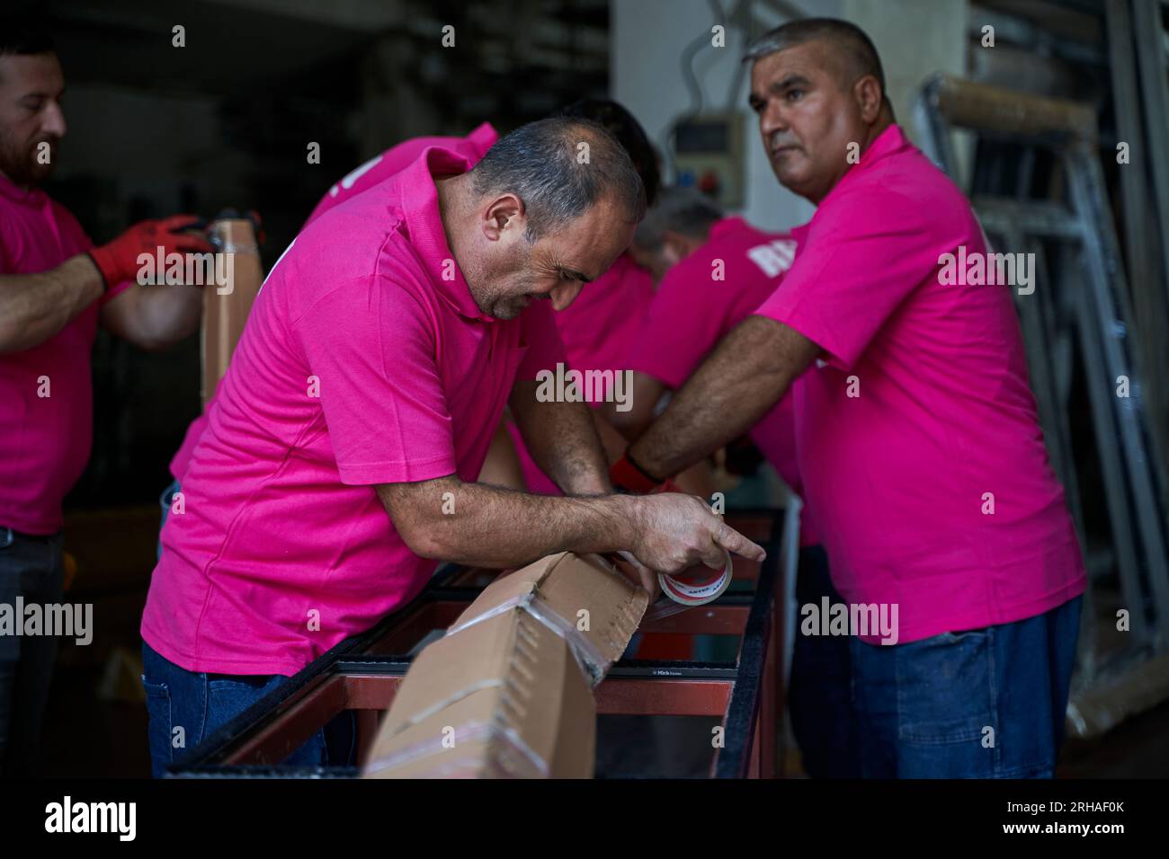 Workers packing cardboard box in warehouse for shipment. an operator ...