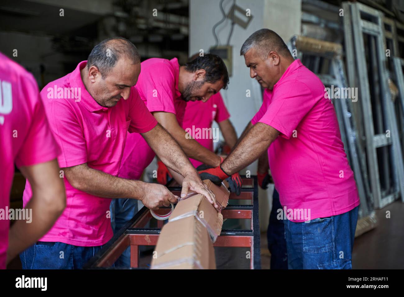 Workers packing cardboard box in warehouse for shipment. an operator ...