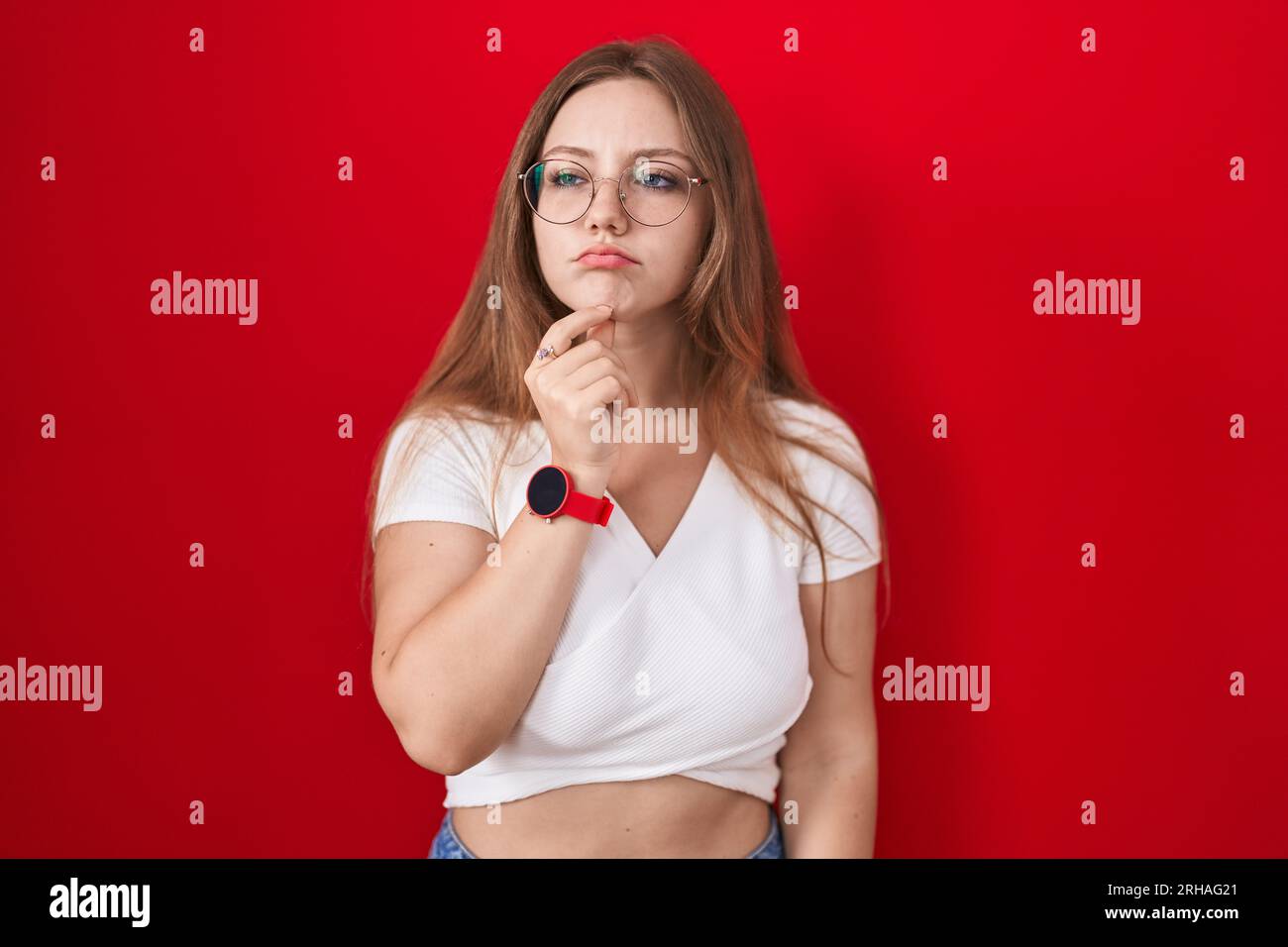 Woman eyes up finger on chin hi-res stock photography and images - Alamy