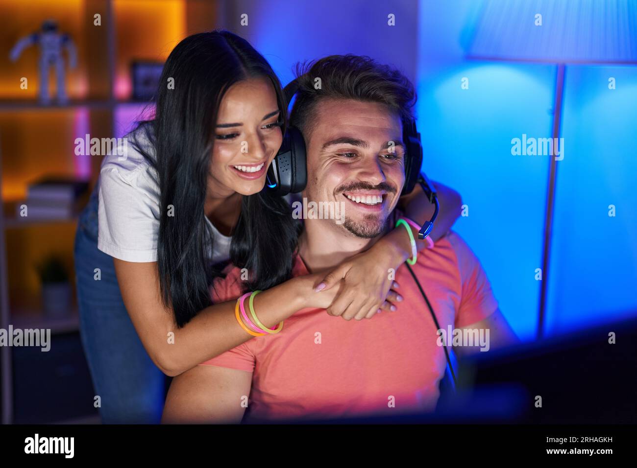 Man and woman streamers playing video game using computer at gaming ...