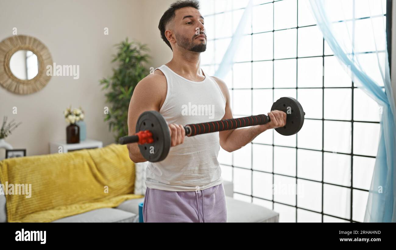 Young arab man using weight training at home Stock Photo Alamy