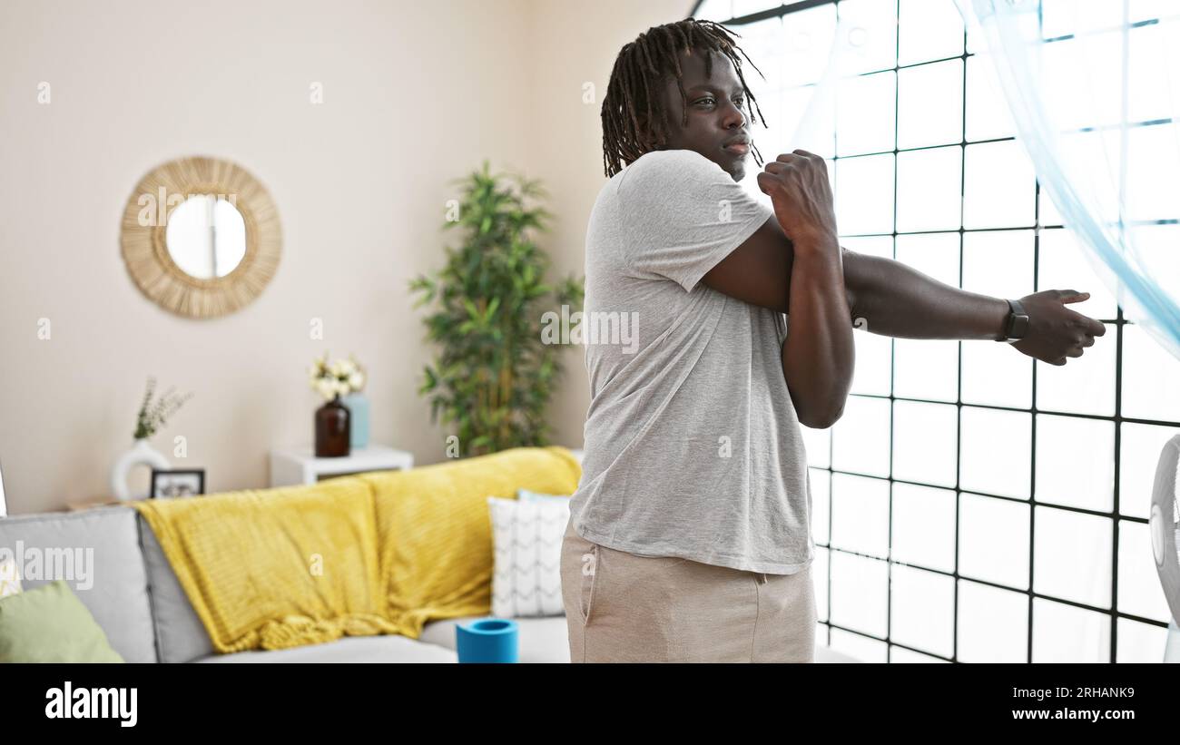 Sporty african man stretching arms hi-res stock photography and images ...