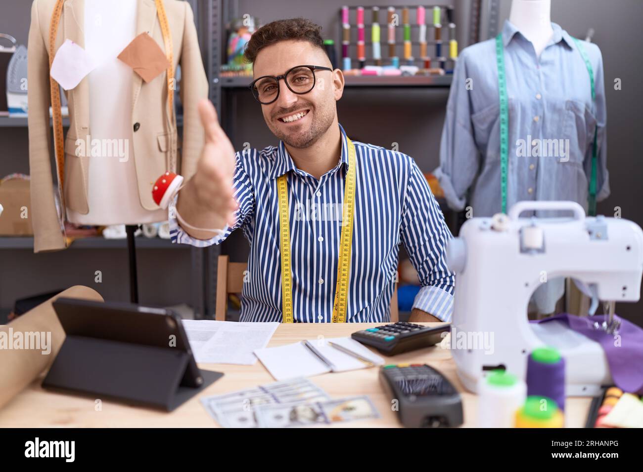 Hispanic man with beard dressmaker designer working at atelier smiling ...