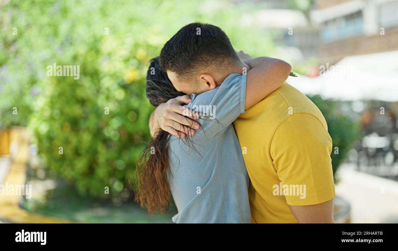 Man and woman couple hugging each other at park Stock Photo - Alamy