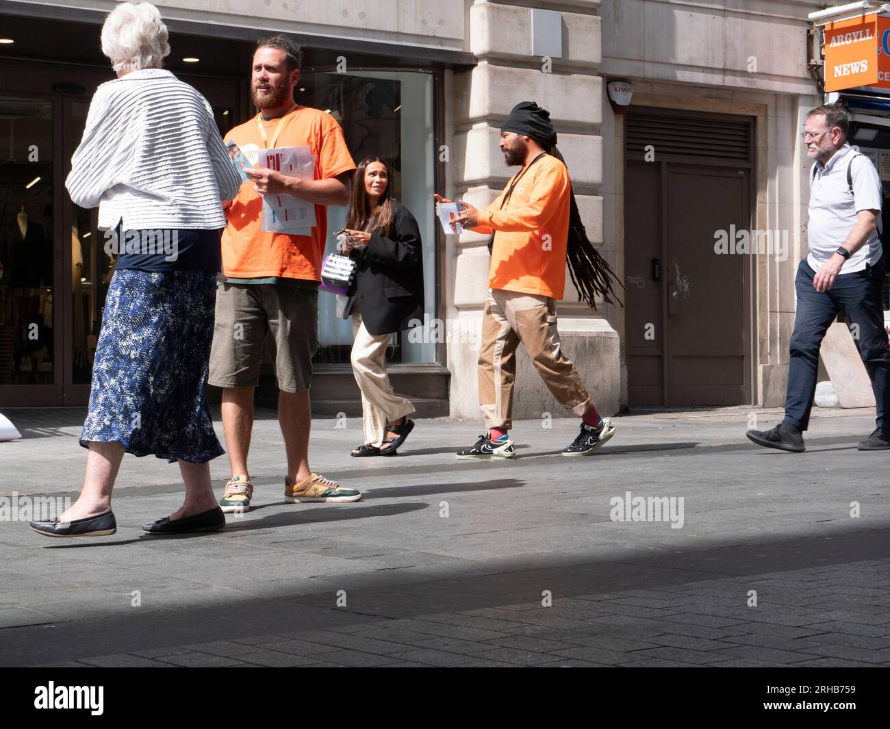 face to face chugger, Street Charity Collector, collecting in Central London for the CentrePoint homeless charitable organisation Stock Photo