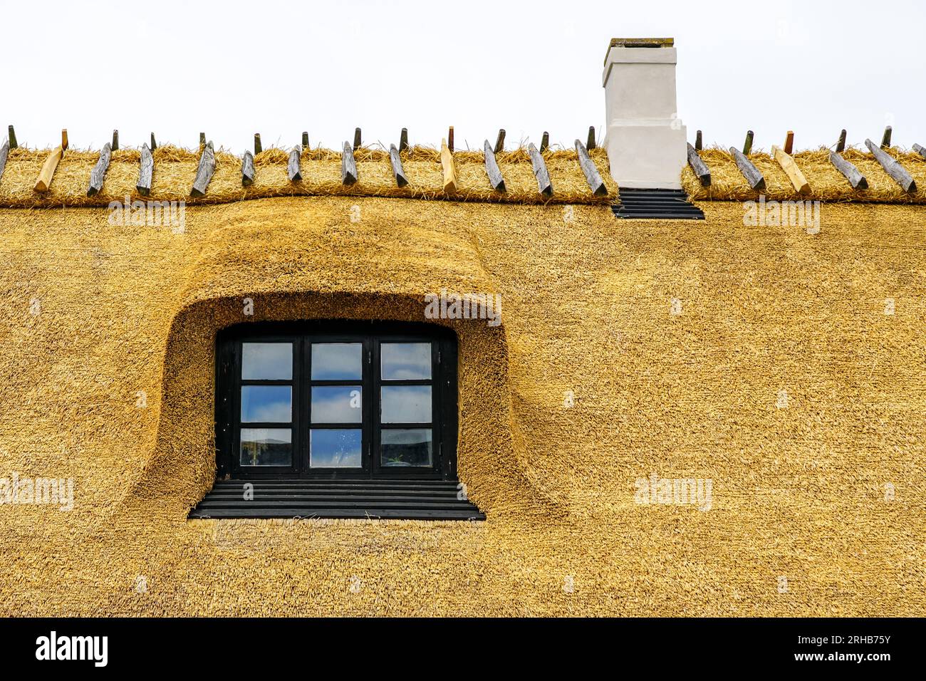 New thatch roof over house with dormer window in Denmark, thatched roof