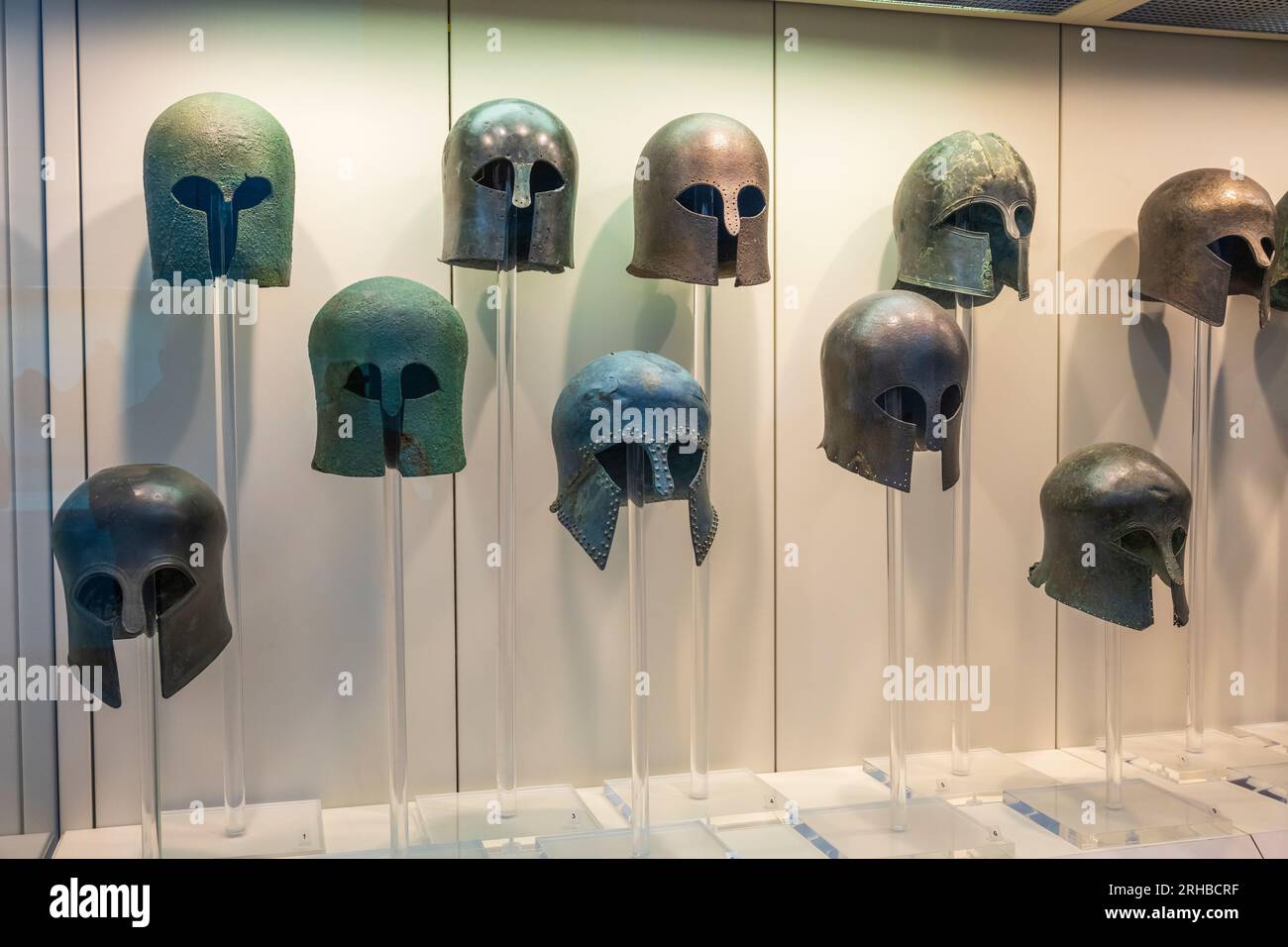 Ancient Greek bronze helmets on display at the Archaeological Museum at ancient Olympia, Elis, Peloponnese, Greece Stock Photo