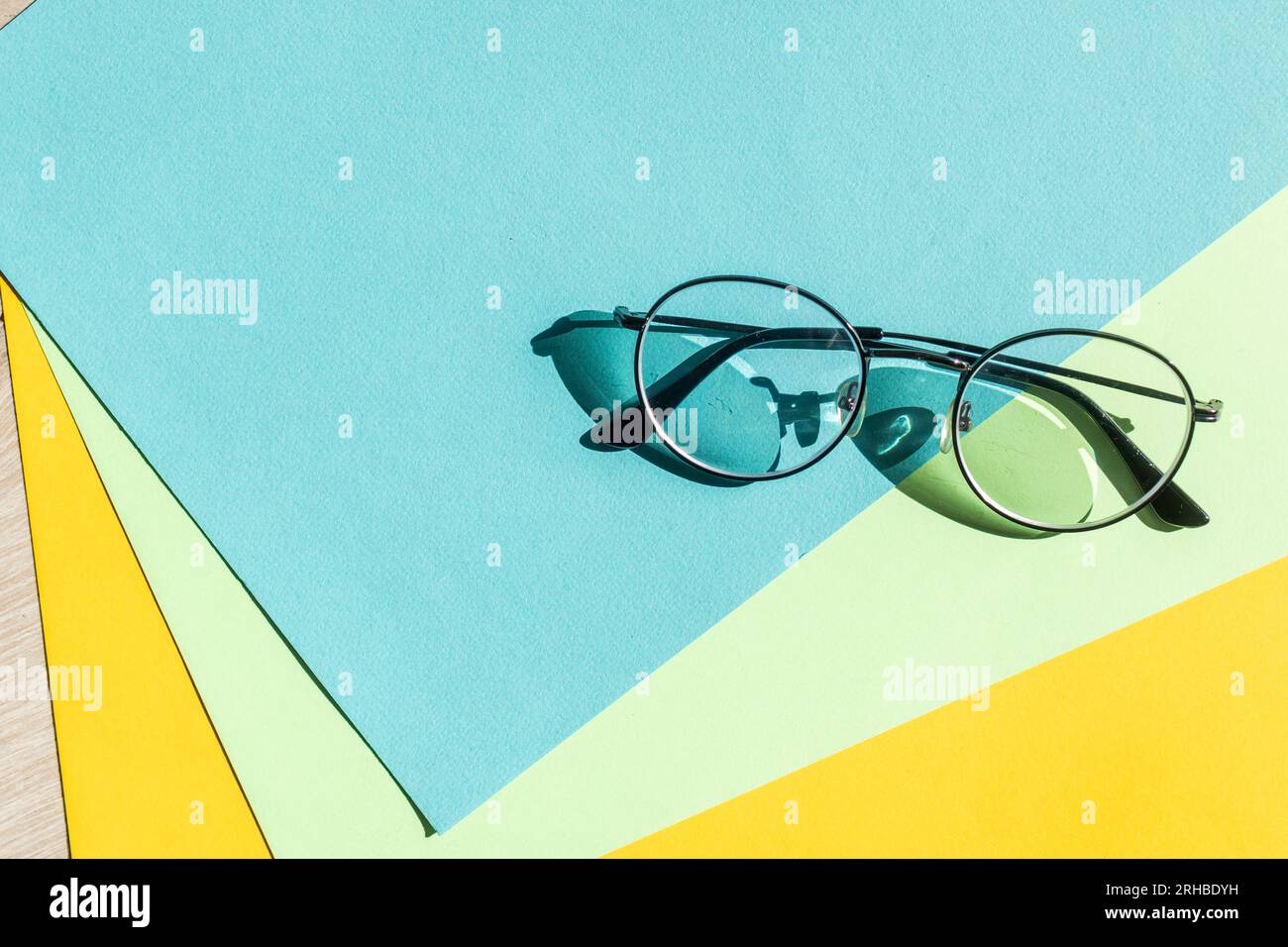 Business black glasses on blue background. Fashion office glasses reading in summer concept for promo banner sale and shopping Stock Photo