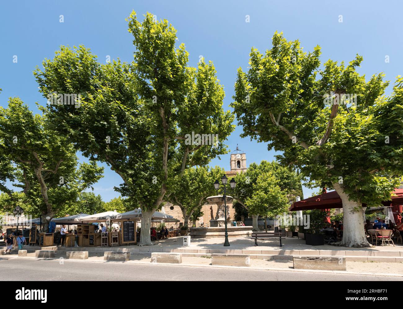 Village square with fountain and restaurant of Maussane les Alpilles