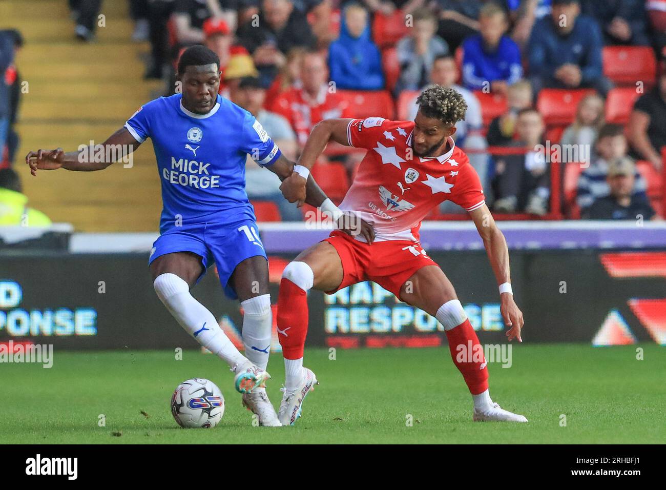 Ephron MasonClark 10 of Peterborough United and Barry Cotter 17 of