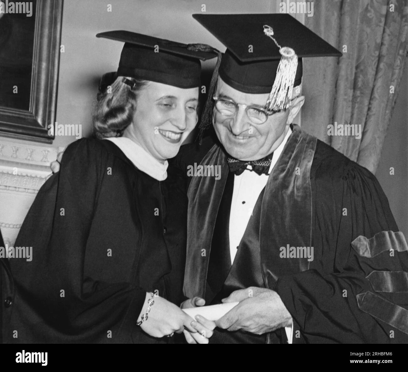 Washington, D.C.:   May 30, 1946 President Truman embraces his daughter Margaret at commencement at George Washington University where she received a degree in history. The President received an honorary Doctor of Laws degreee. Stock Photo