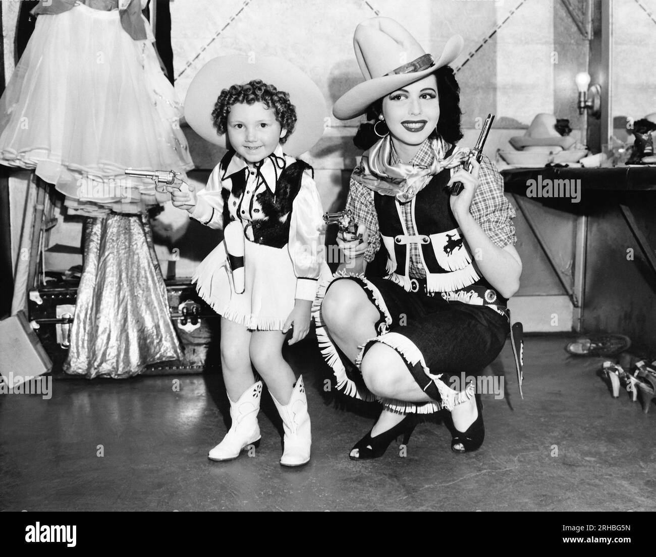 Oakland, California:   May 9, 1940 Four year old 'Baby Streamline' of the 1940 Golden Gate International Exposition and Ann Miller, dancing star of  George White's Scandals, team up for Oakland's Golden Forties Fiesta preceding the opening of the Exposition on Treasure Island. Stock Photo