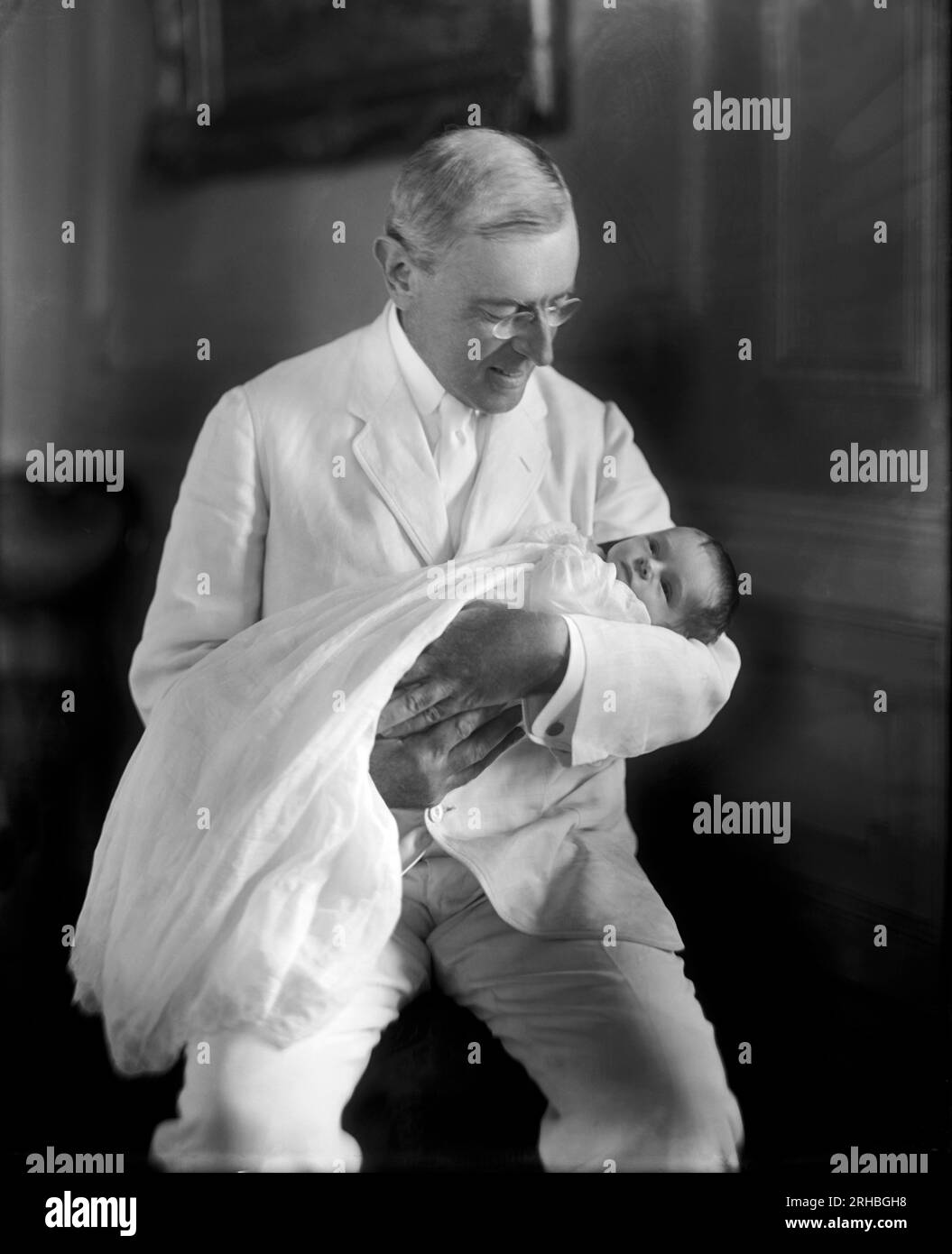 Washington, D.C.  1915 President Woodrow Wilson holding his granddaughter Ellen Wilson McAdoo. Stock Photo