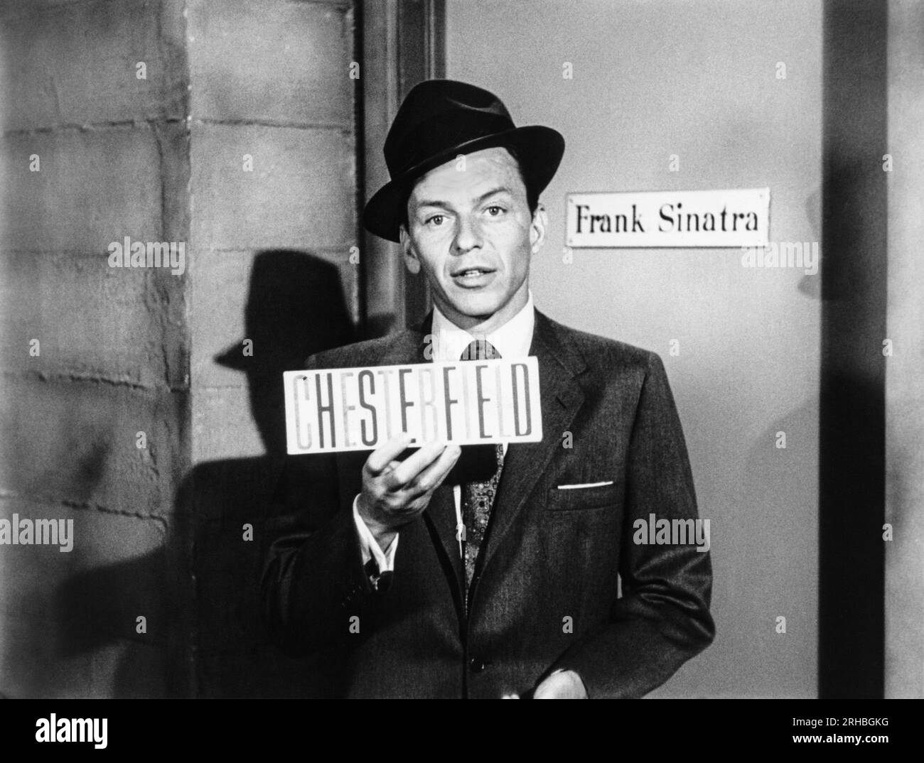 United States:  c. 1957 Frank Sinatra holding a sign for Chesterfield cigarettes. The Frank Sinatra Show was sponsored by them. Stock Photo