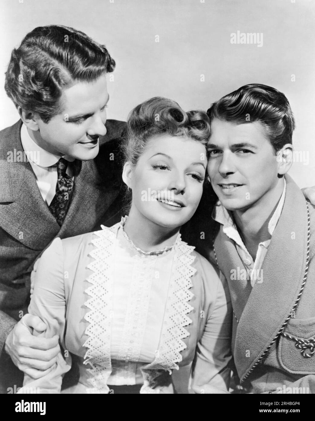 Hollywood, California:  1942 A promotional photograph for the film 'Kings Row' with L-R: Robert Cummings, Ann Sheridan, Ronald Reagan Stock Photo