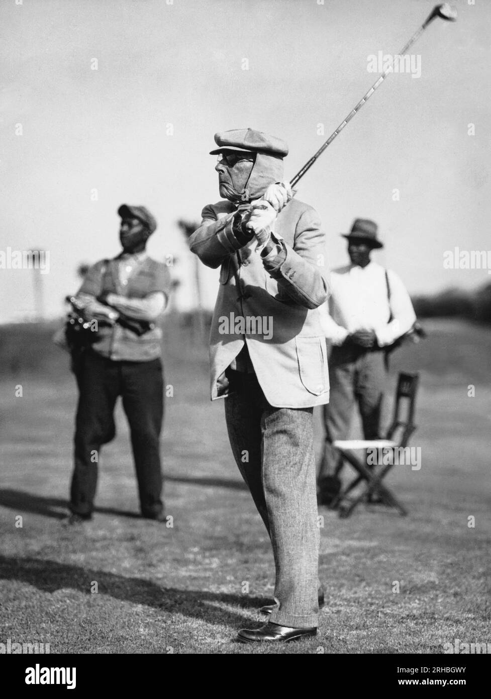 Ormond Beach, Florida:  c.  1932 Oil man and philanthropist John D. Rockefeller as he plays golf on his private golf course at the Casements. Stock Photo