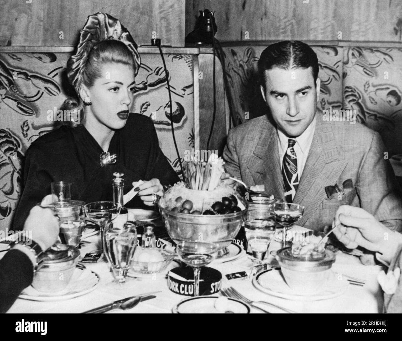 New York, New York:  November 14, 1941 Actress Lana Turner and orchestra leader Artie Shaw having dinner at the Stork Club. They are together for the first time since their divorce and are now planning their second marriage. Stock Photo