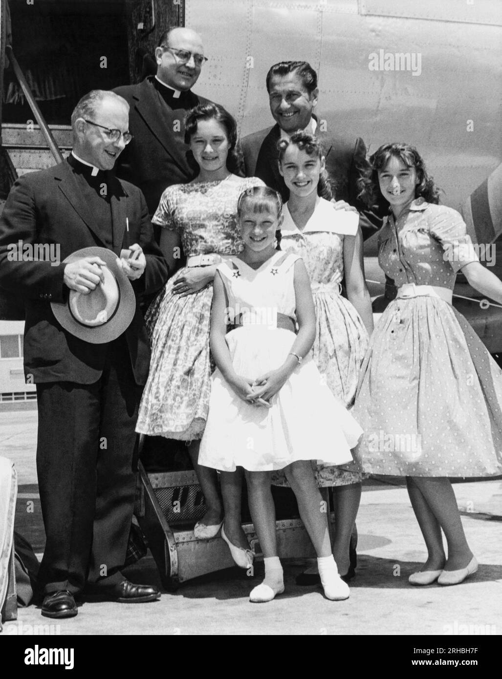 MIlwaukee, Wisconsin:  June, 1958 Lawrence Welk (right, rear) and the Lennon Sisters are greeted by Marquette University Fathers M. G. Barnett and Adrian Kochanski upon their arrival there by plane. Stock Photo