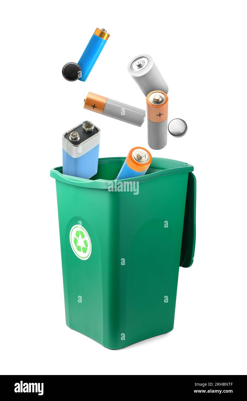 Alkaline batteries falling into trash bin isolated on white. Recycling