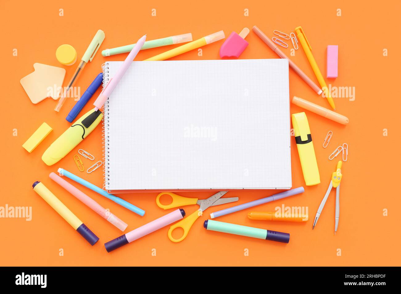 Composition with blank notebook and different school supplies on color ...