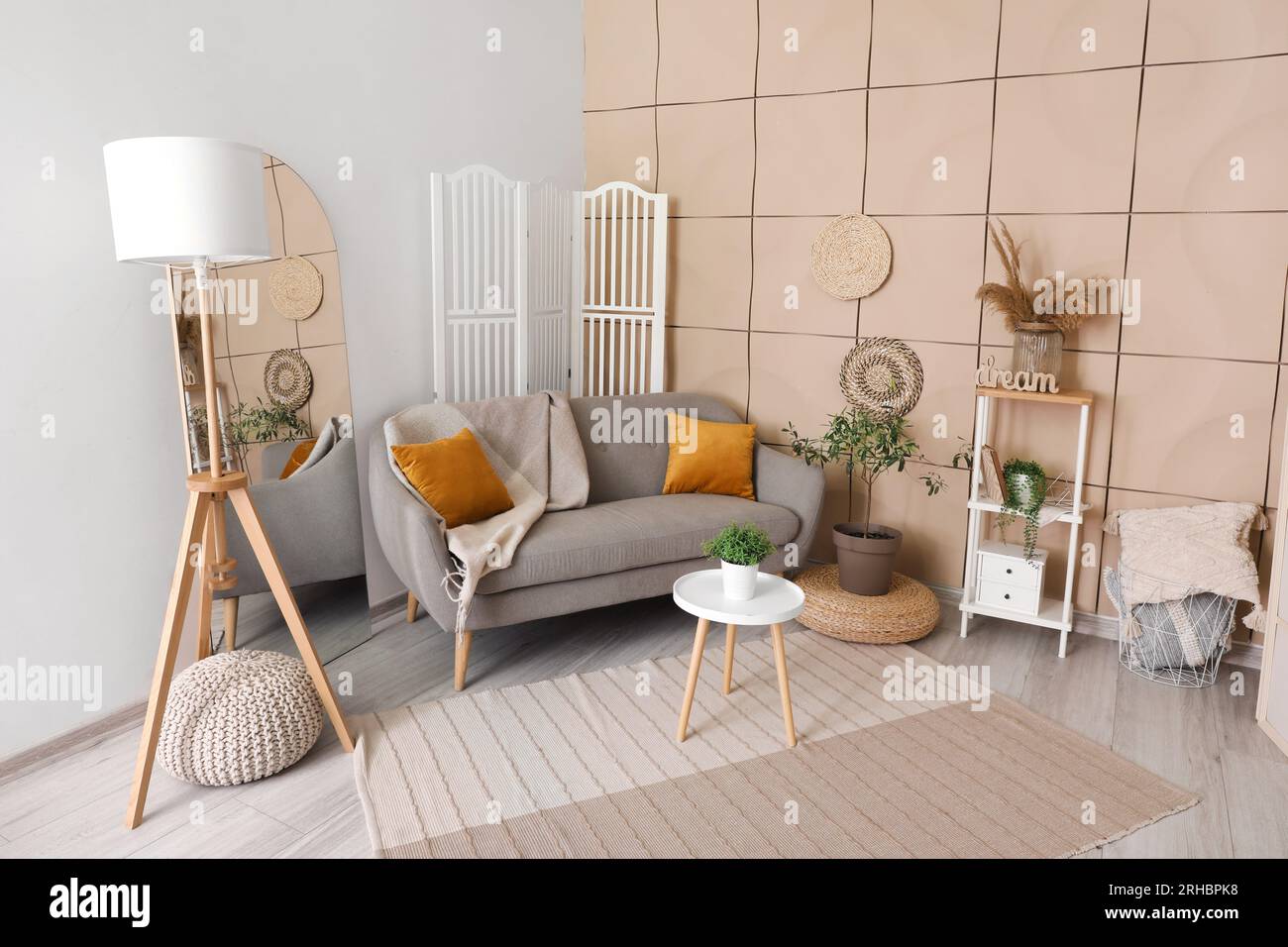 Interior of living room with grey sofa, coffee table and mirror Stock ...