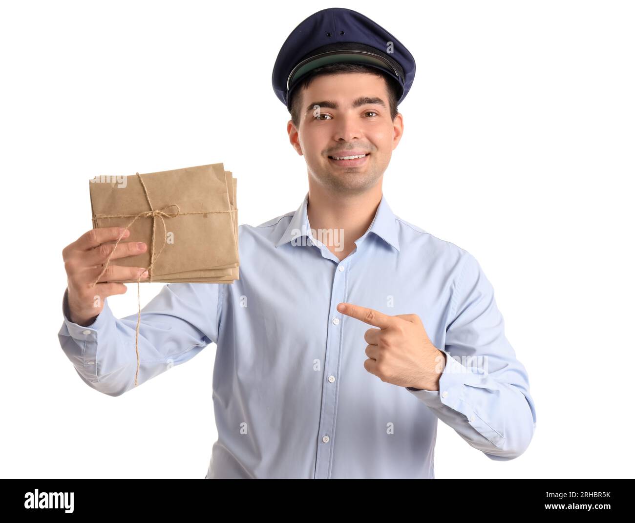Young postman pointing at letters on white background Stock Photo - Alamy