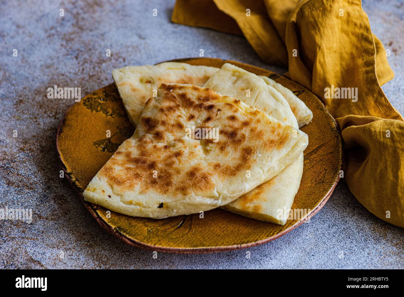 Close-up of Georgian cheese bread slices (Imeruli khachapuri) on a plate Stock Photo