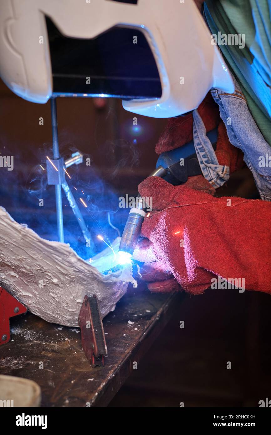 Side view of unrecognizable industrial worker in protective helmet and ...