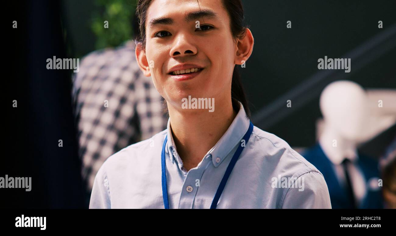 Asian employee preparing store for opening, arranging stylish