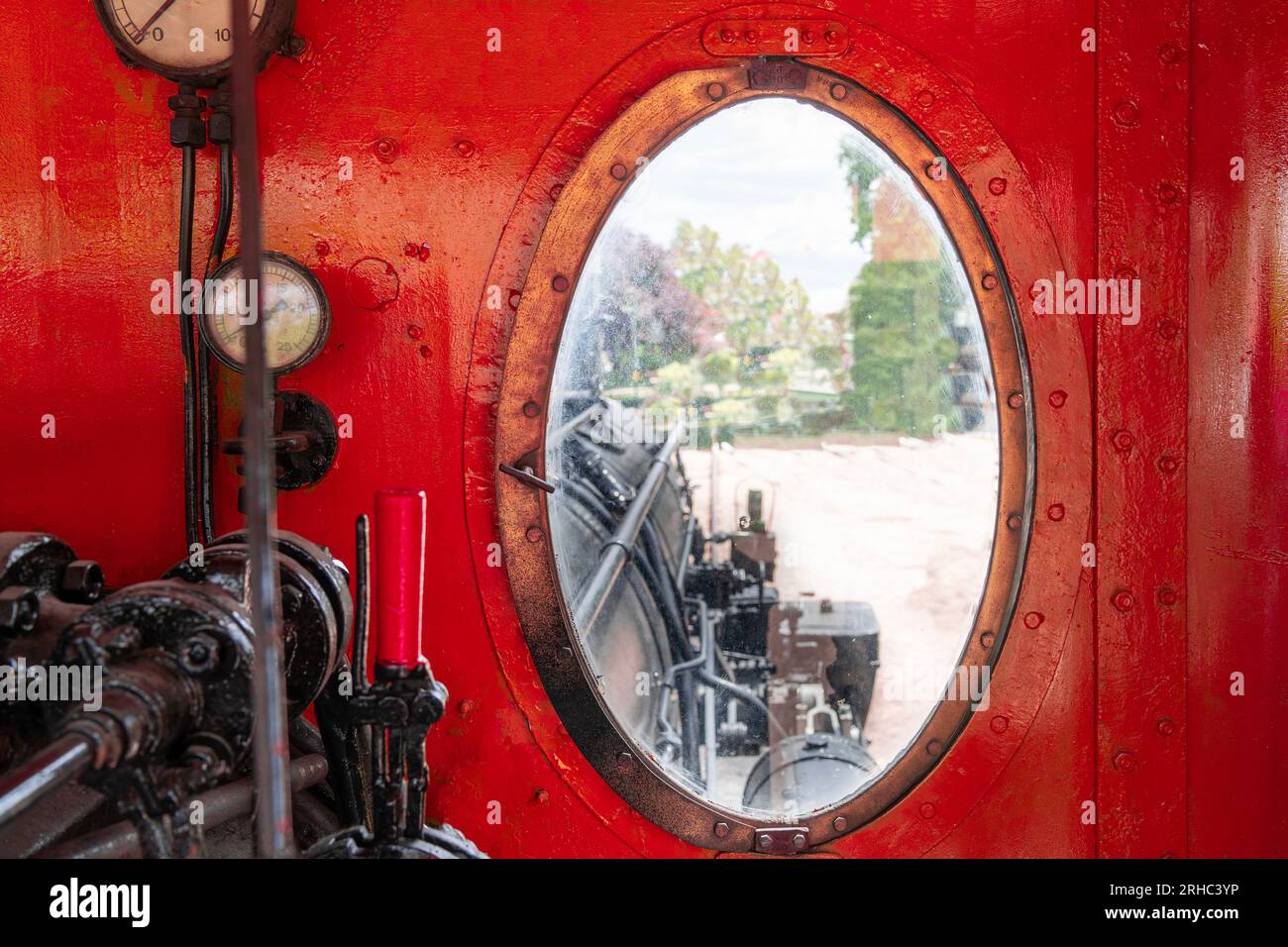 View from the window of the red-painted driver's cab of an old steam locomotive Stock Photo