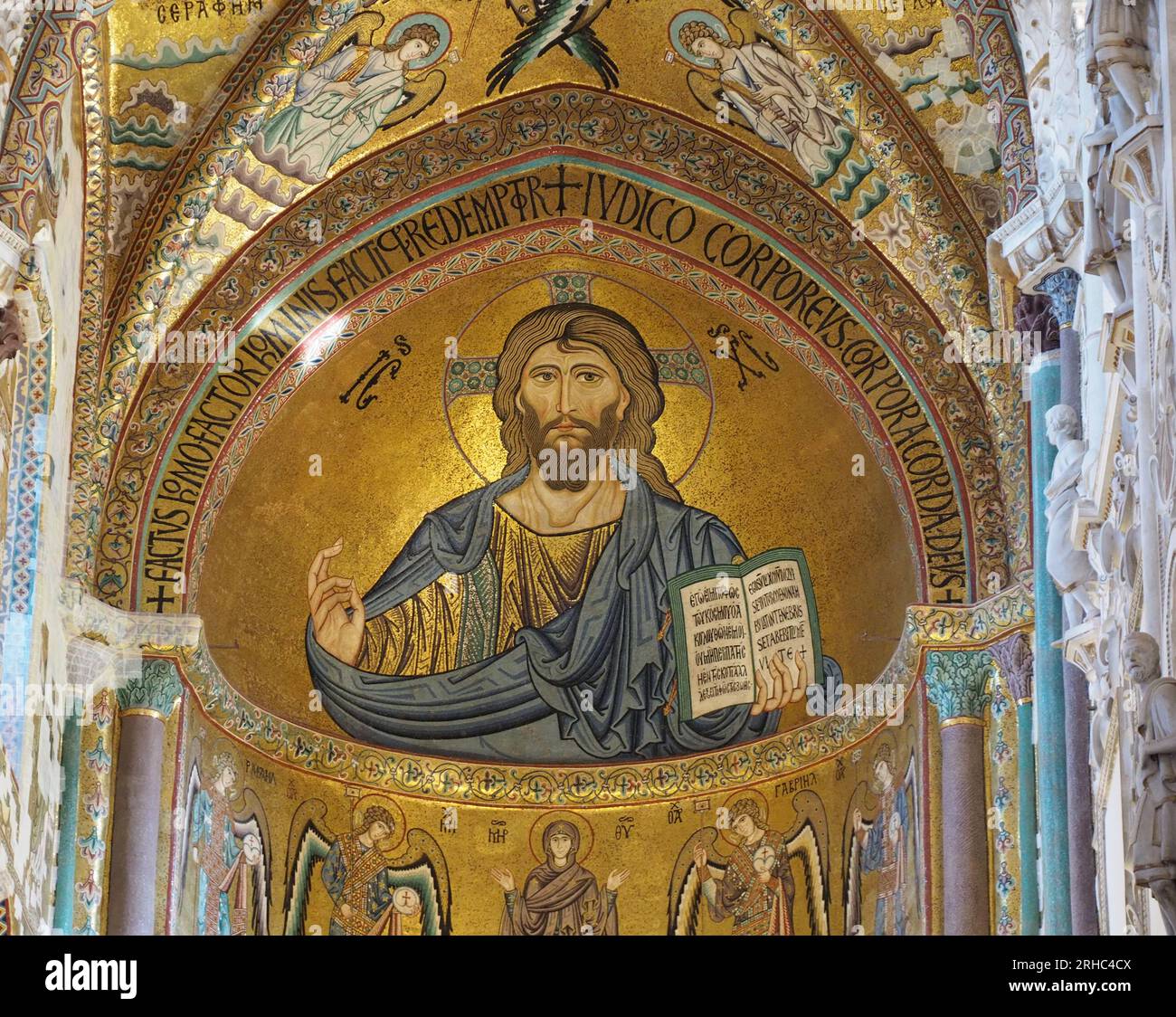 Mosaic in the apse of the cathedral at Cefalu portrays Christ Pantokrator.  The figure carries the Gospel of John in his left hand. Stock Photo