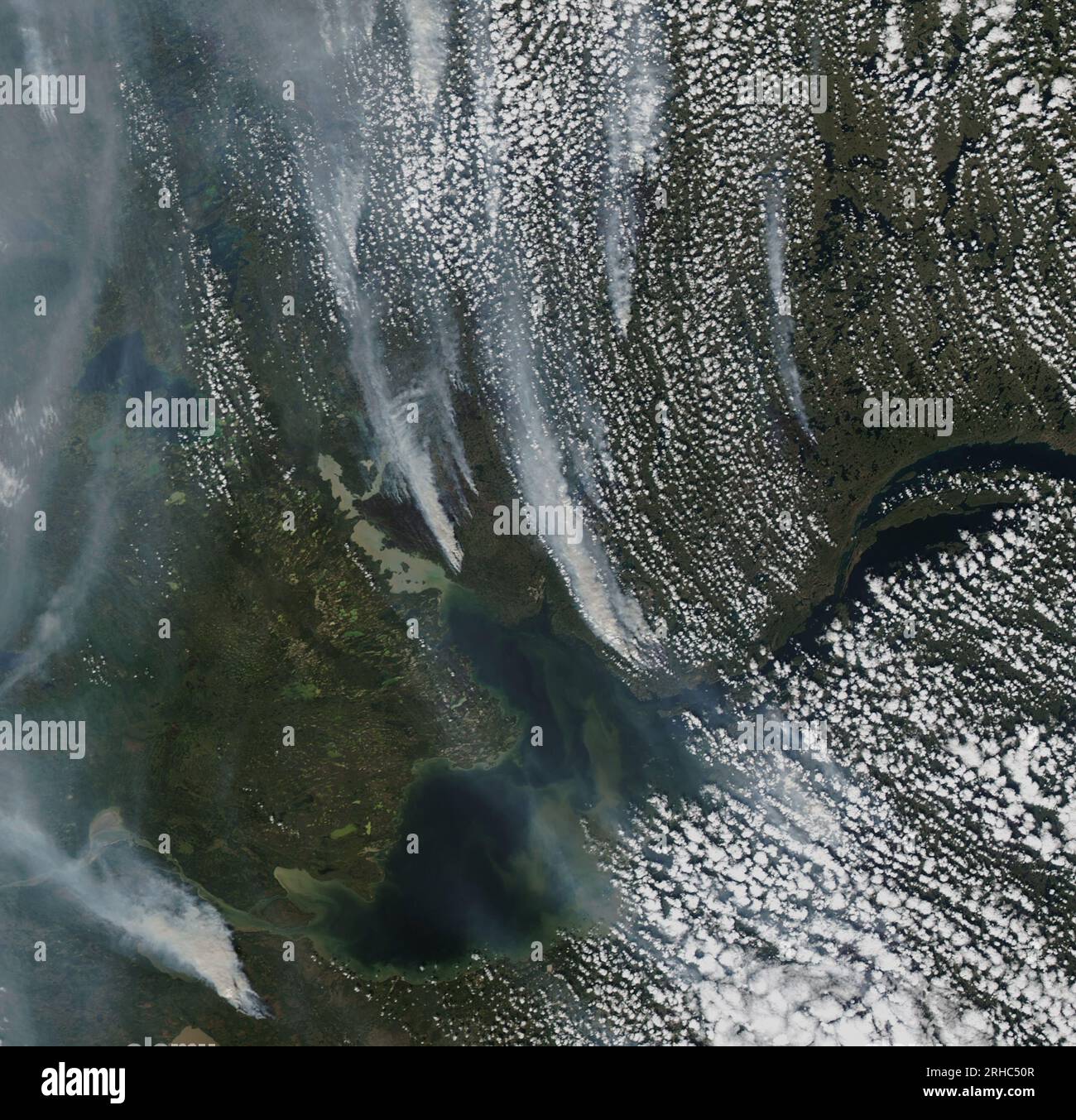Usa. 8th Aug, 2023. The Moderate Resolution Imaging Spectroradiometer on NASA's Aqua satellite captured this image of dense plumes of smoke streaming from dozens of large fires in the Northwest Territories. Several of these fires raged around Yellowknife, the province's capital and largest city, where firefighters are conducting controlled burns around the city's perimeter as a cautionary measure. These fires follow major outbreaks of fire in Alberta, British Columbia, Nova Scotia, and Quebec, in May, June, and July. Credit: NASA Earth/ZUMA Press Wire/ZUMAPRESS.com/Alamy Live News Stock Photo