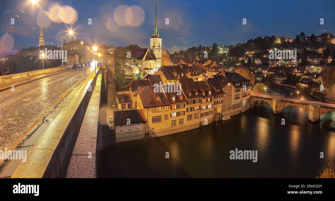 Incredible  autumn view of Bern city at night. Scene of Aare river with Nydeggkirche - Protestant church. Location: Bern, Canton of Bern, Switzerland, Stock Photo