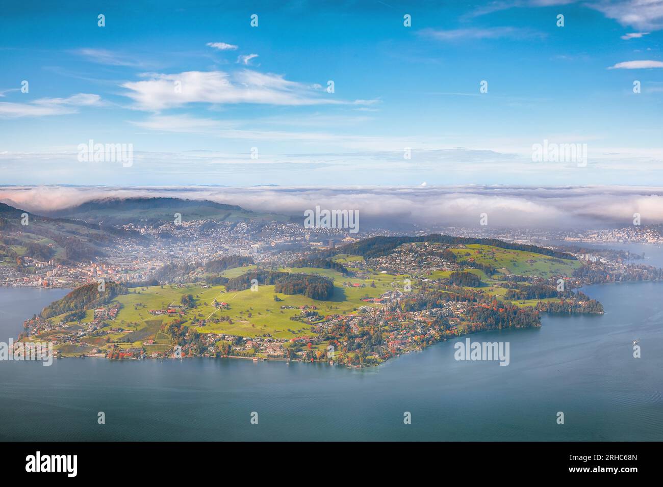 Breathtaking autumn view of Stansstad city and Lucerne lake with mountaines and fog. Poppular travel destination in Swiss Alps.   Location: Stansstad, Stock Photo