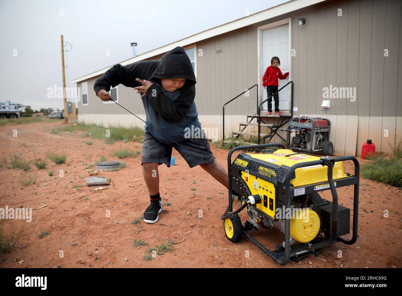 FILE Jayden Long starts the generator behind his Kaibeto home on the