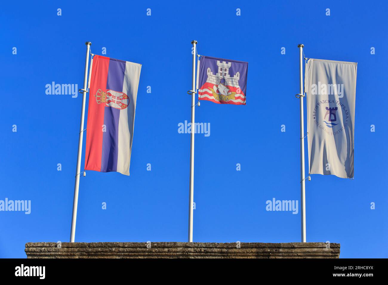 The flags of Serbia, Belgrade and Belgrade Fortress flying proudly side by side at the Belgrade Fortress in Belgrade, Serbia Stock Photo
