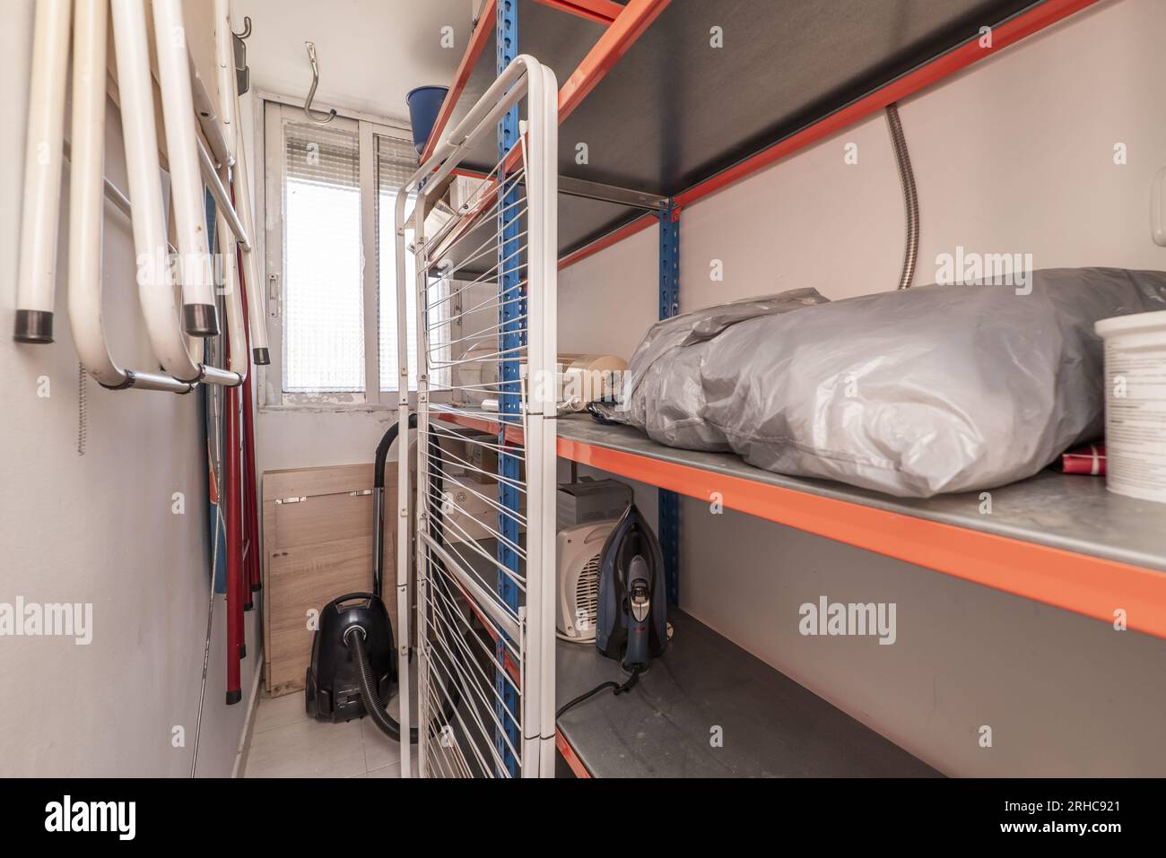 Small room dedicated to storage with metal shelves Stock Photo - Alamy