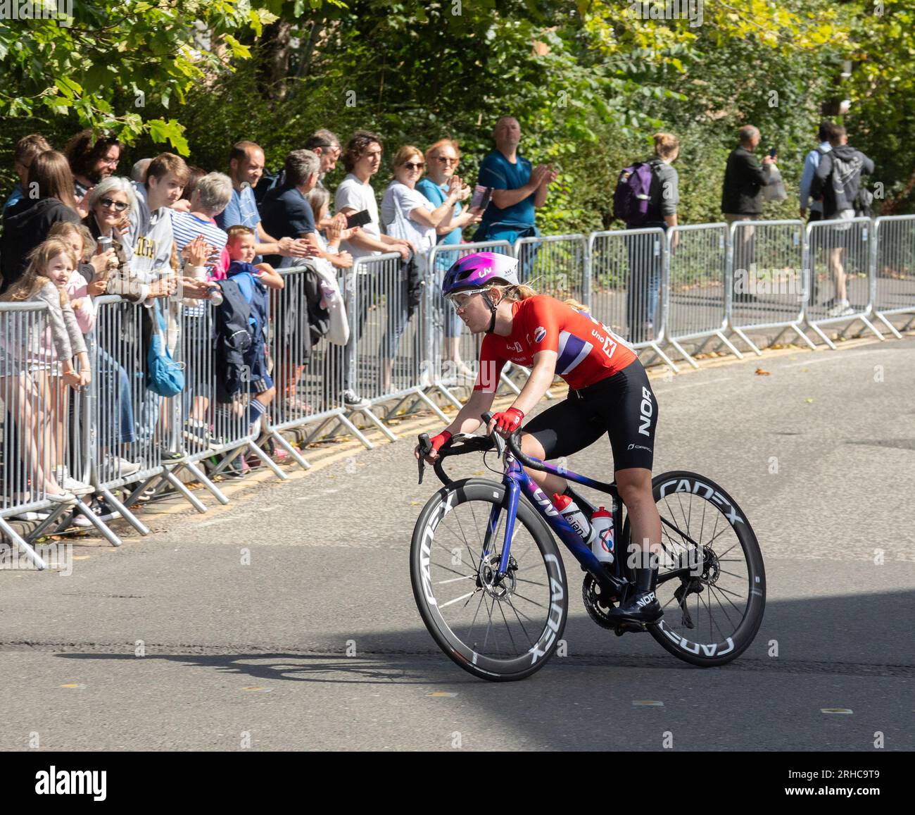 Ingvild Gaskjenn of Norway cycling in Glasgow during the UCI elite women's world championship road race 2023. Spectators are cheering Stock Photo