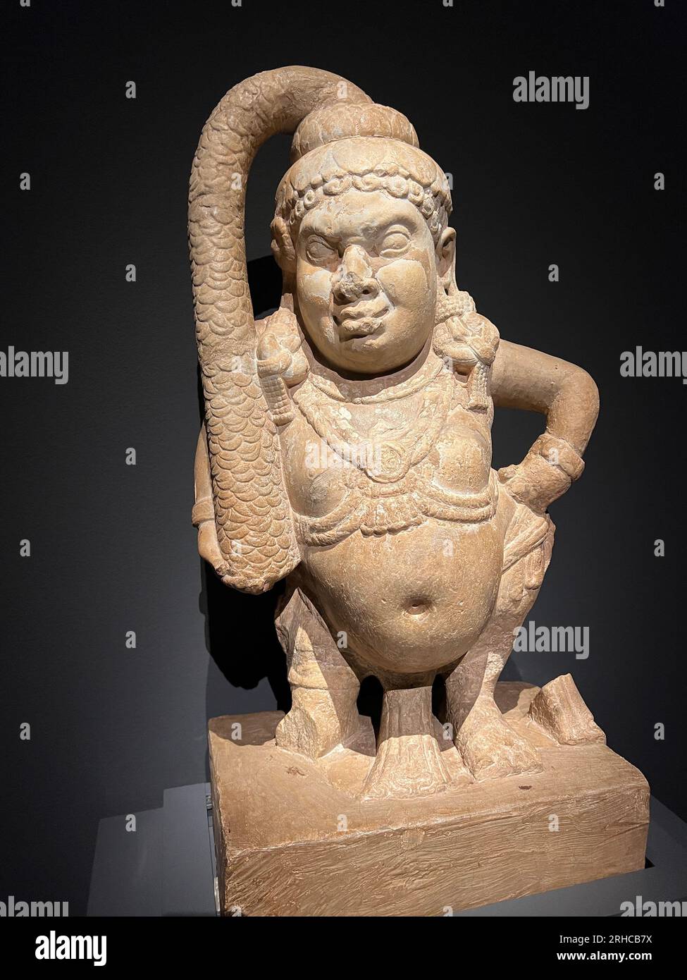 Yaksha Padmanidhi, the wealth guardian with a lotus crown.    Nagarjunakonda, Guntur district, Andra Pradesh Ikshvaku, 3rd-4th century CE.    Padmanidhi and his companion Sankhanidhi served as the chief attendants of Kubera, god of wealth, guarding his hoarded riches. The figure here has the squat physique of the goblin protectors of the spirit world. Limestone Stock Photo