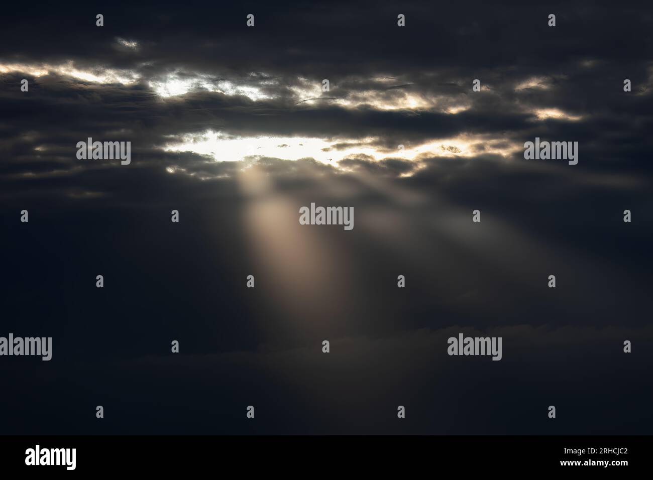 Sun shines through storm clouds hi-res stock photography and images - Alamy