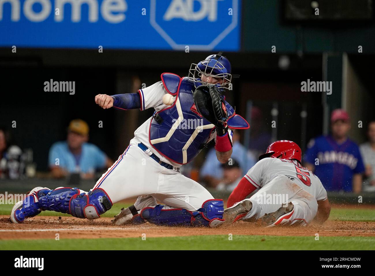 Texas Rangers catcher Jonah Heim reaches out for the throw to the plate ...