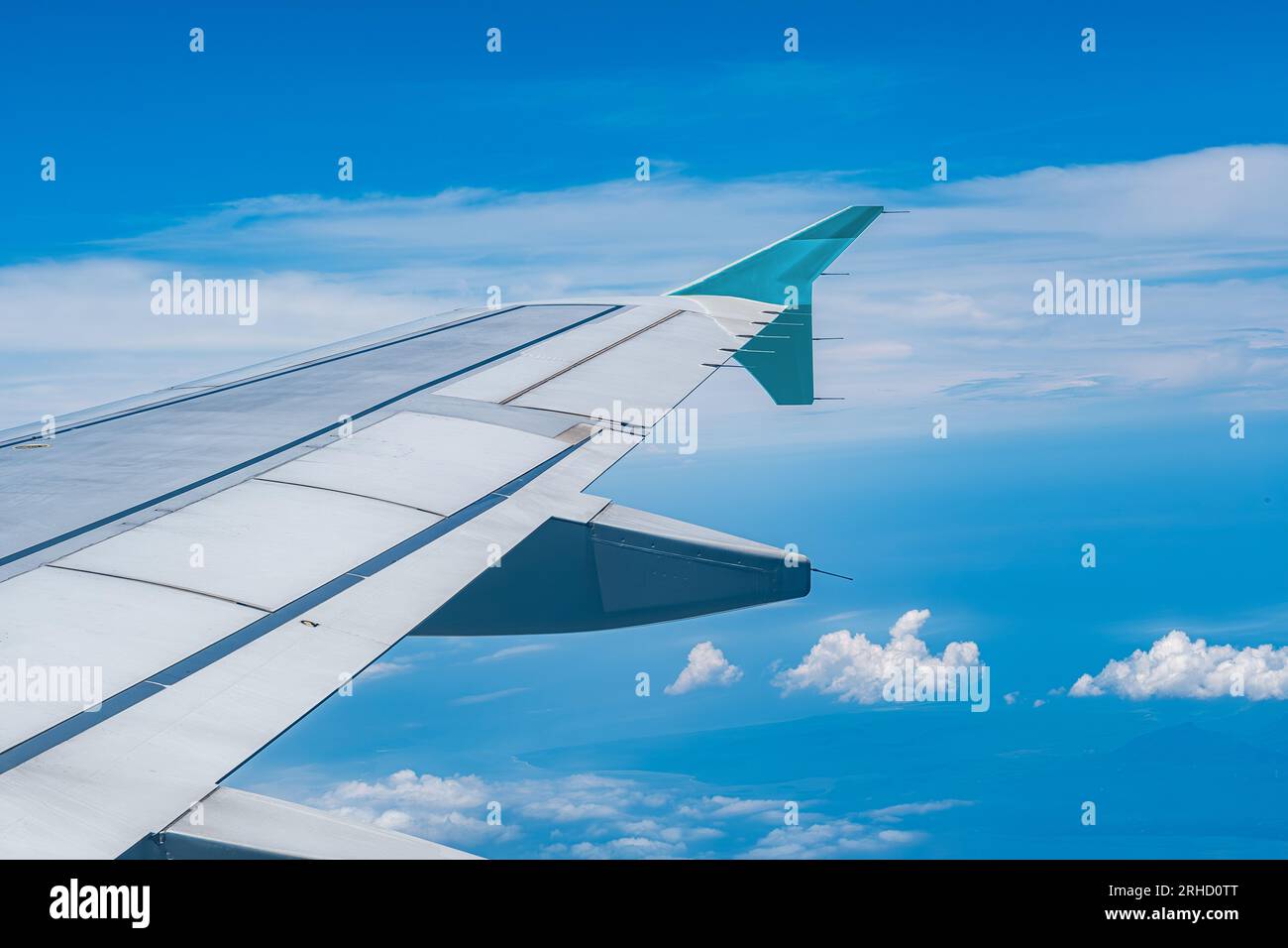 Image of airplane wing flying above the clouds Stock Photo - Alamy