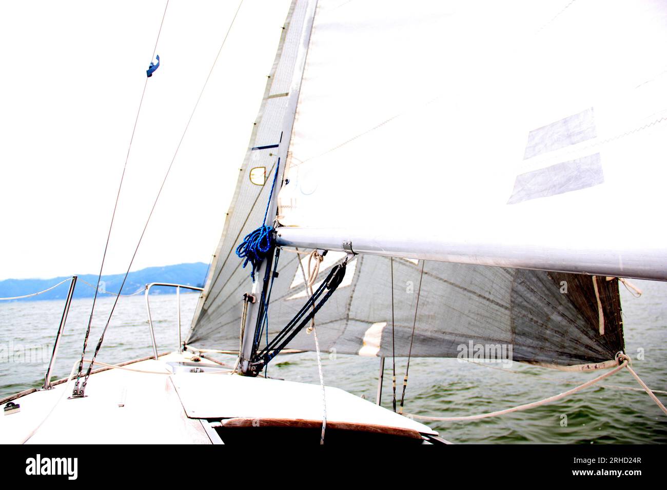 Parts of a sailboat that is sailing on the lake with sails out, bow ...