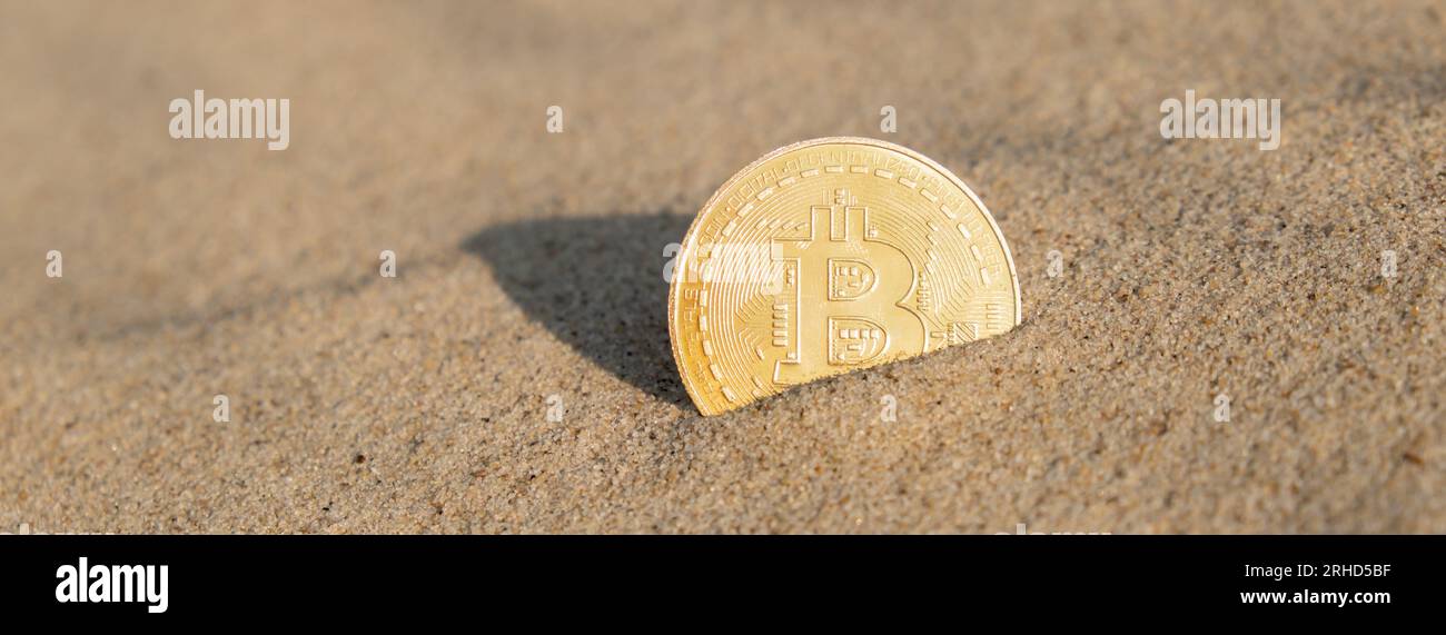 Bitcoin Coin cryptocurrency In Sand On Beach. Freelance, stock exchange BTC sign Concept mining bitcoin for holidays and vacation. Payment For Nature And Unlimited Possibilities. Copy Space Worldwide digital money and stock business Stock Photo
