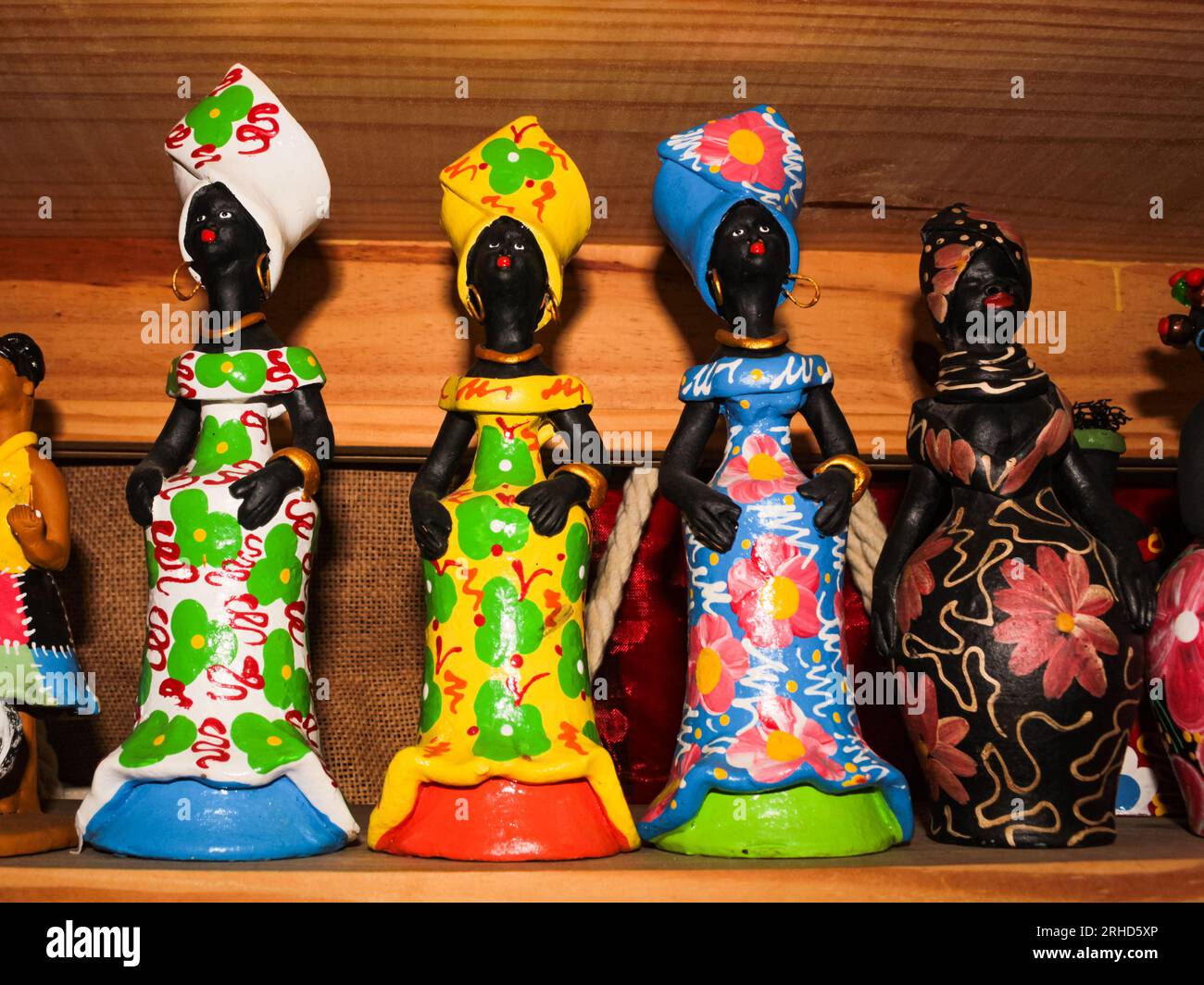 Colorful clay dolls, painted in vibrant colors, for sale to tourists in Northeast Brazil. Stock Photo