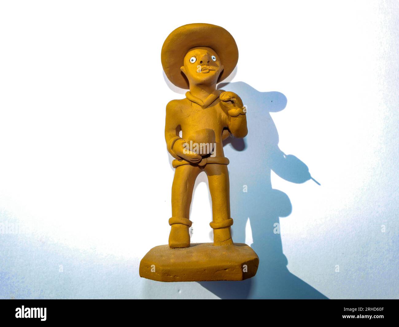 Small clay statue that portrays the northeastern man, it is a souvenir sold to tourists in the market in northeastern Brazil. Stock Photo