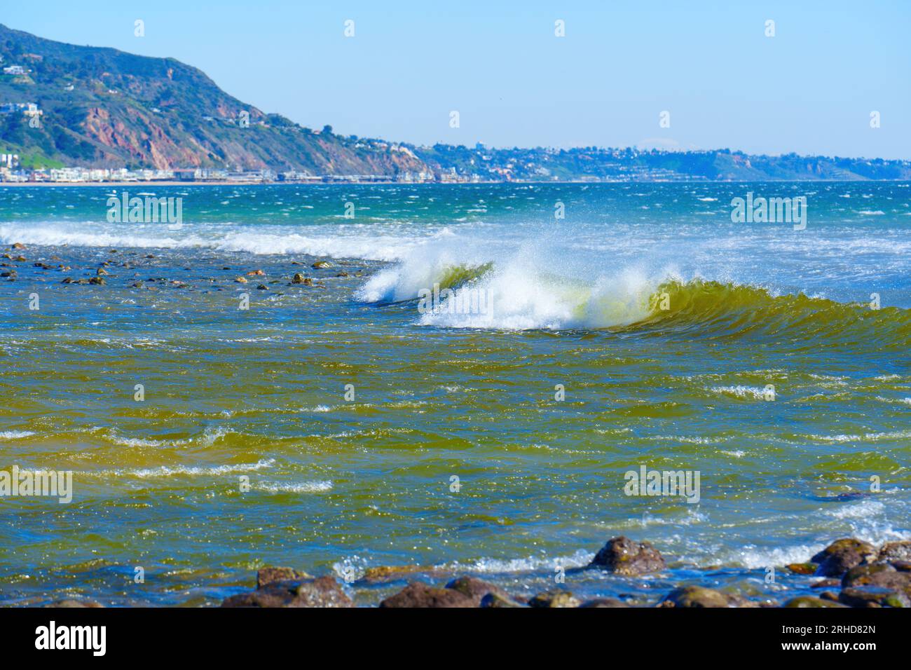 Stunning seascape, featuring the mesmerizing ocean waves, majestic mountains and the distant view of Malibu Beach. Stock Photo