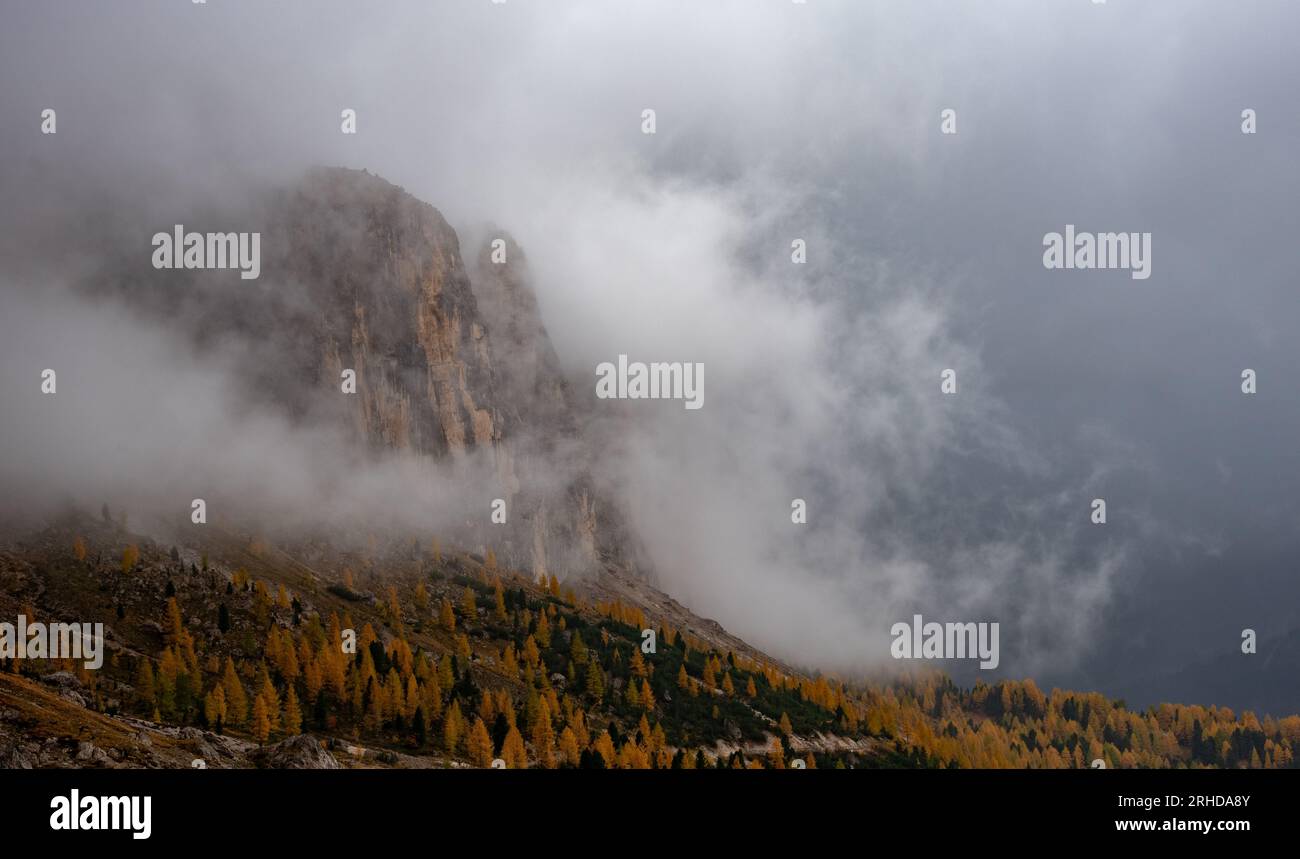 Dolomite mountain peaks covered in fog during sunrise Stock Photo - Alamy