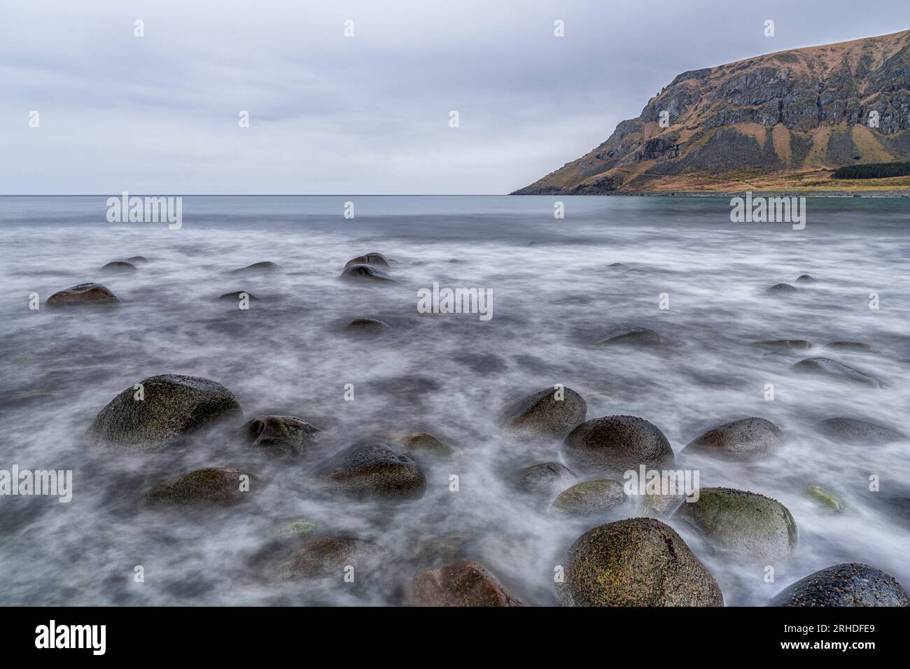 Waves crashing on rocks in the wild landscape of Unstad beach, Vestvagoy, Lofoten Islands, Norway Stock Photo